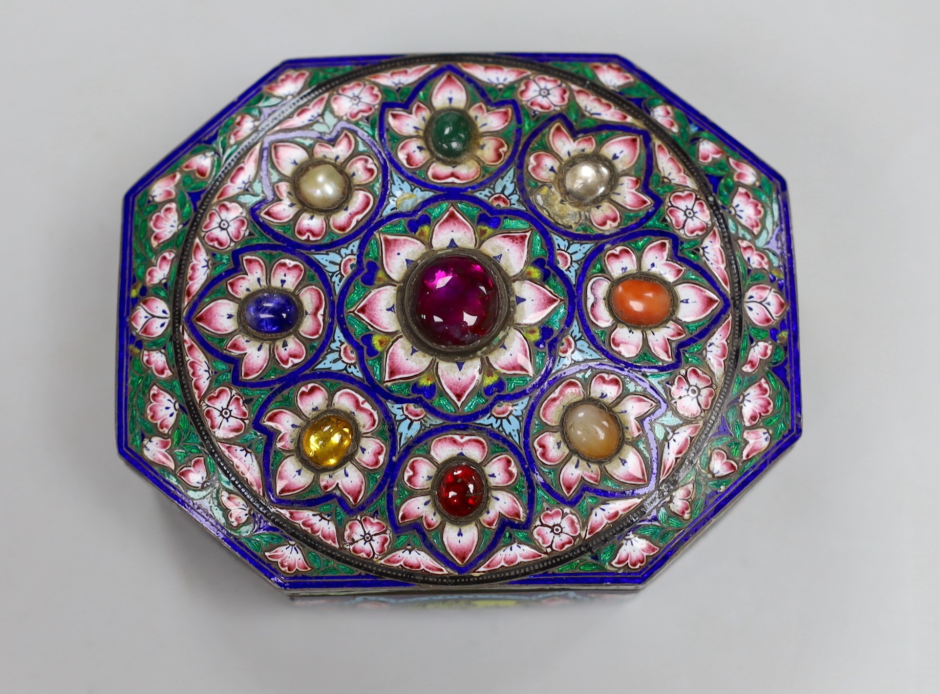 An early 20th century Indian gem set and enamelled gilt white metal trinket box, 10cm long